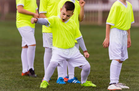 Kids soccer football - young children players celebrating の写真素材