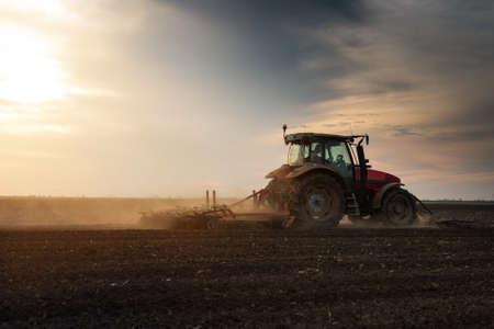 Tractor plowing fields -preparing land for sowingの写真素材