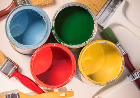 Paint brushes and opened paint cans with colorsの写真素材