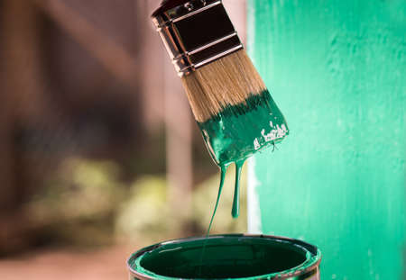 Man is painting metal surface with a brushの写真素材