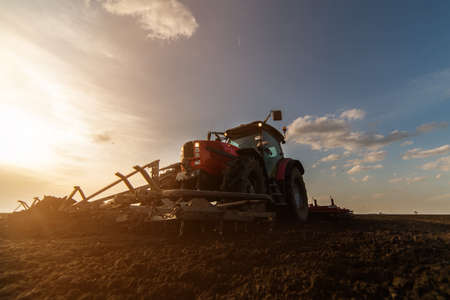 Tractor plowing fields -preparing land for sowing