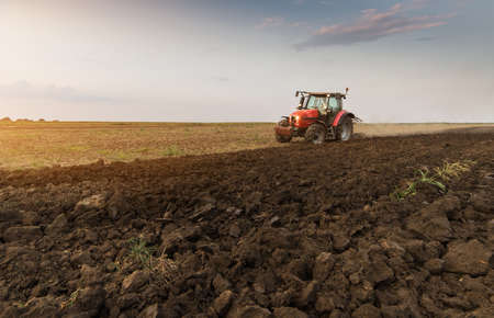 Farmer plowing stubble fields