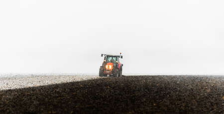 Tractor plowing a field in winter