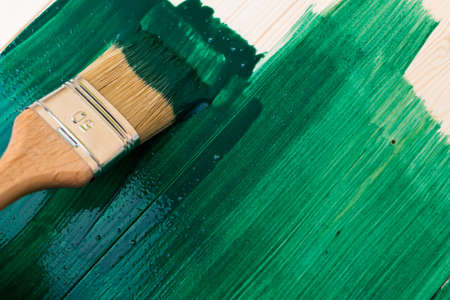 Paintin wooden surface with a brush