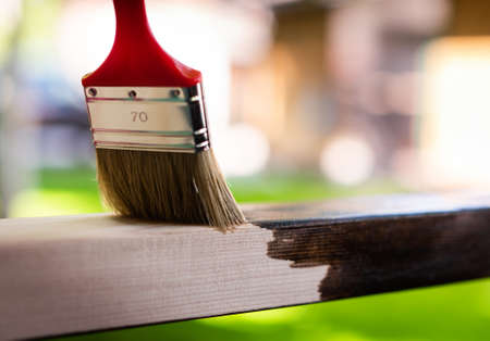 Paintin wooden surface with a brush