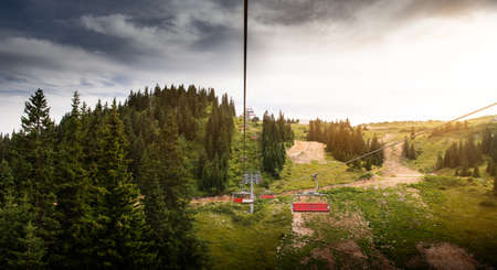 Ski lifts climb the hill on a summer dayの写真素材