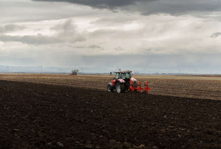 Tractor plowing fields -preparing land for sowingの写真素材