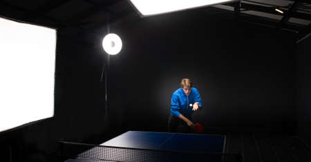 A boy is playing table tennis.on white backgroundの写真素材