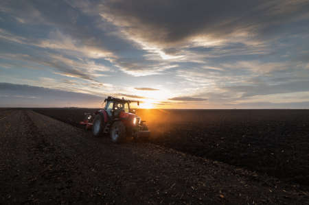 Tractor plowing fields -preparing land for sowingの写真素材
