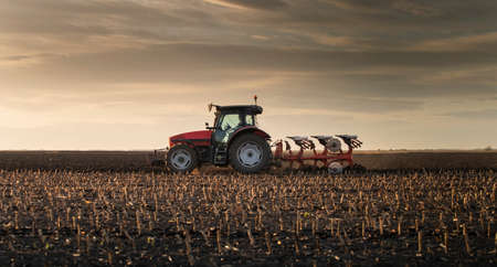 Tractor plowing fields -preparing land for sowing