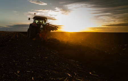 Tractor plowing fields -preparing land for sowingの写真素材