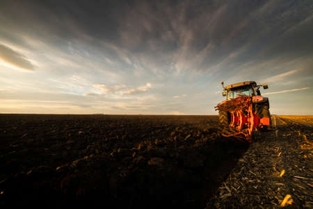Tractor plowing fields -preparing land for sowingの写真素材