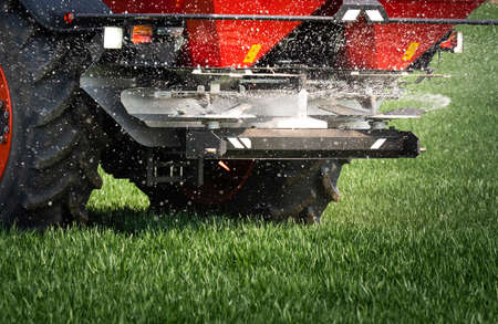Tractor spreading artificial fertilizers. Transport, agricultural.