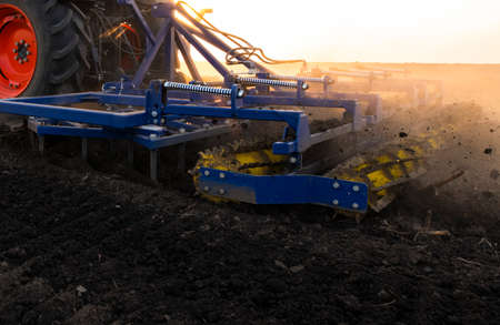 Farmer preparing his field in a tractor ready for spring.