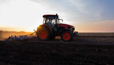 Farmer preparing his field in a tractor ready for spring.の写真素材