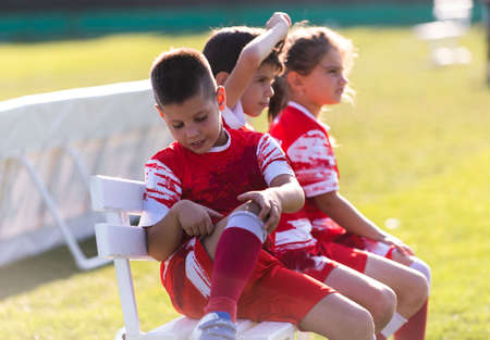 Soccer Team on the sidelines watching game.