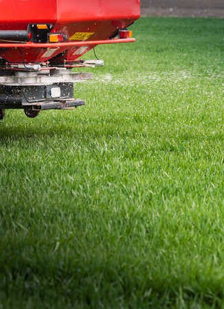 Tractor spreading artificial fertilizers. Transport, agricultural.