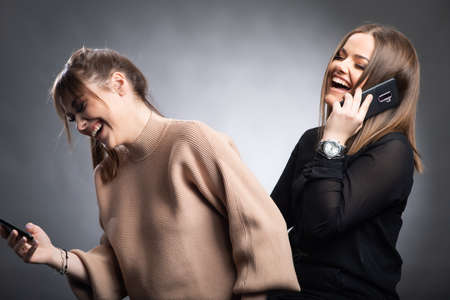 Teenage Girls Taking Selfie On Mobile Phone in studioの写真素材