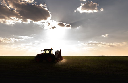 Tractor spraying pesticides on soy field  with sprayer at springの写真素材