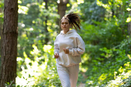 Young beautiful caucasian woman jogging workout training.