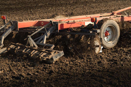 Tractor preparing land for sowing. Tractor with cultivator handles field before planting. Preparing...
