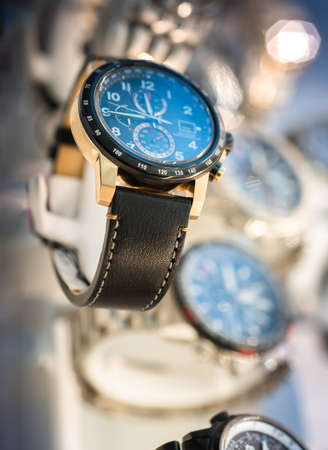 Luxury  watches on display in store window, shallow depth of field.