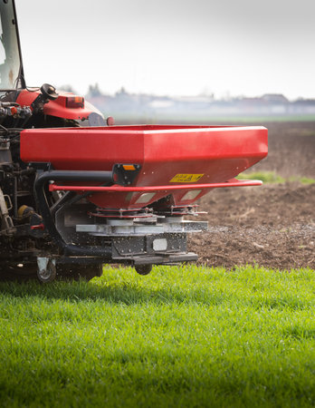 tractor fertilizing in wheat field