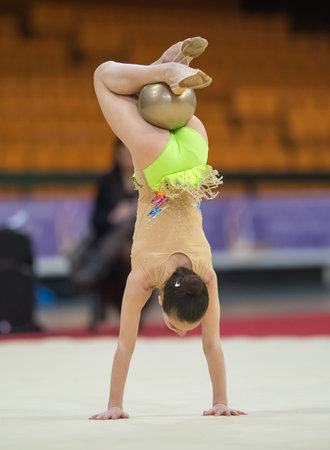 girl in beautiful gymnastic dress doing exerciseの写真素材