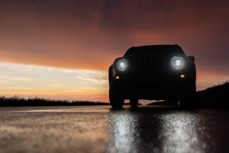 lonely car is going by empty highway through in the evening,の写真素材
