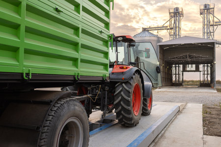 Loading maize or wheat into metal silo for storage after the harvest.