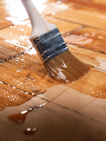 Wood Staining Closeup. Closeup of a hand applying stain on woodの写真素材