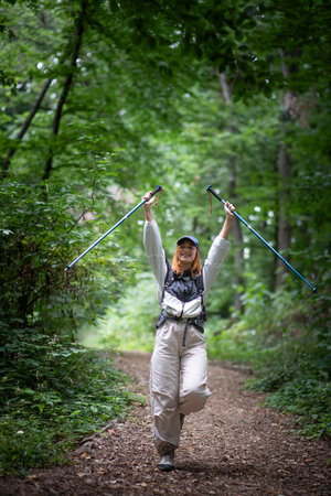Forest hike trail hiker woman walking  nature background in fall season.の写真素材