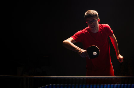 Close up of a table tennis player returning the ball