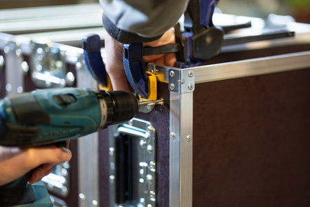 worker produces  flight cases in workshop