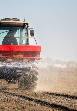 Tractor spreading artificial fertilizers. Transport, agricultural.