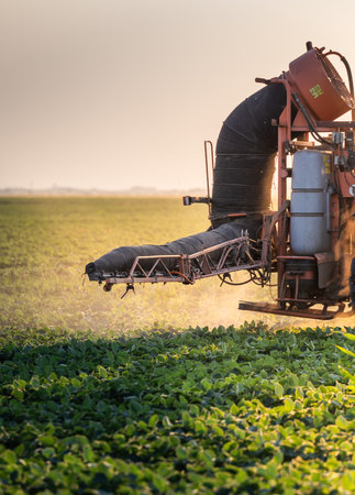 Tractor spraying pesticides on soybean field  with sprayer at springの写真素材