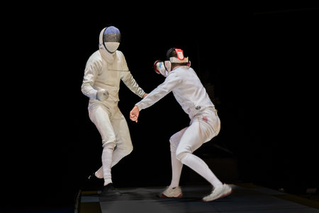 Fight at a fencing competition. Two fencing athletes fight on professional sports arena