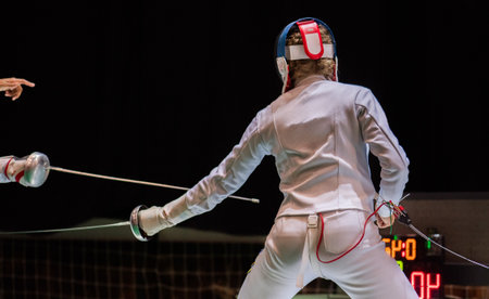 Two female fencing athletes fighting on professional sports arena