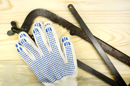 Hacksaw and glovesの写真素材