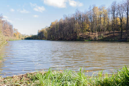Landscape on a city pond in sunny autumn dayの写真素材