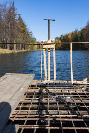 Dam on a city pond in sunny autumn dayの写真素材