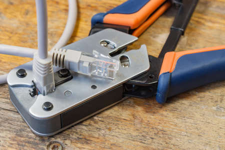 Crimping tool for mounting of the connectors RJ45 on the desktop in a workshopの写真素材