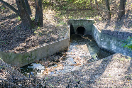 Dam on a city pond in sunny autumn dayの写真素材
