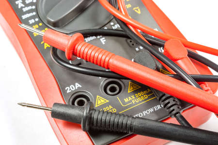 Digital multimeter with probes on a white background