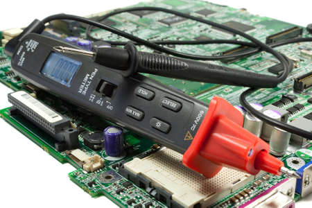 Digital multimeter pen type on the motherboard in a workshopの写真素材