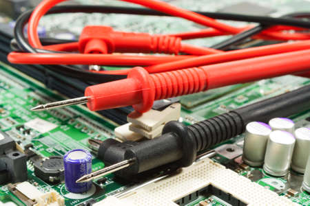 Multimeter probe on the motherboard in a workshopの写真素材