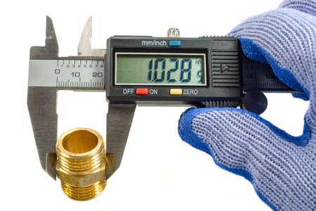 Measurement of plumbing fitting with digital caliper in the master's hand in a glove