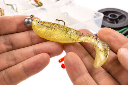 Silicone bait for fishing spinning in the hands of the fishermanの写真素材