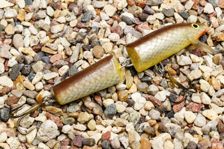 Yellow wobbler with triple hooks for a spinning on the stony groundの写真素材