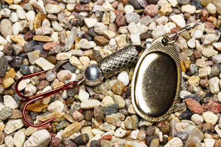 Yellow metal fishing bait with red triple hook for a spinningの写真素材